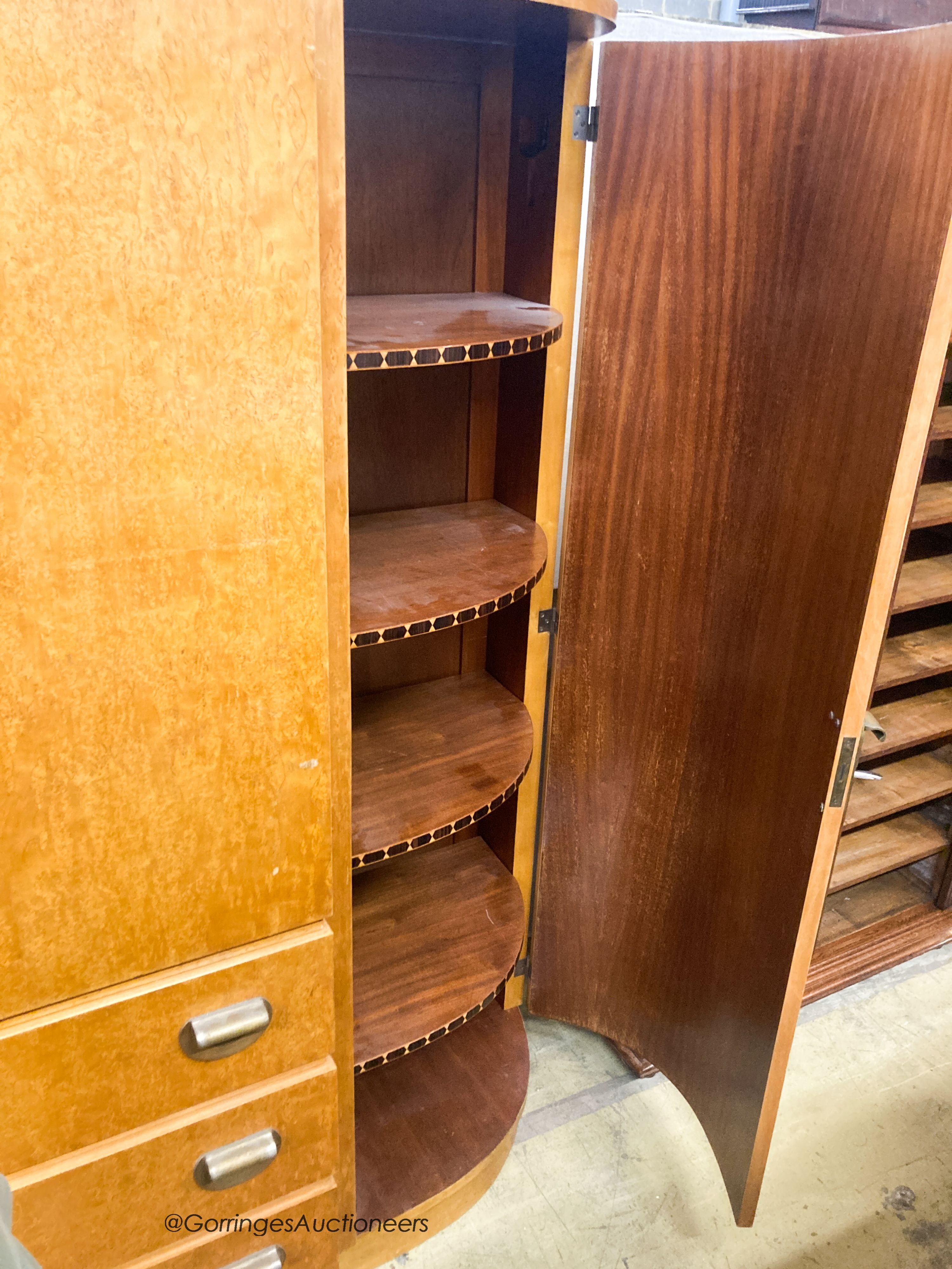 A French Art Deco birds eye maple and mahogany compactum wardrobe, W.174cm D.51cm H.181cm